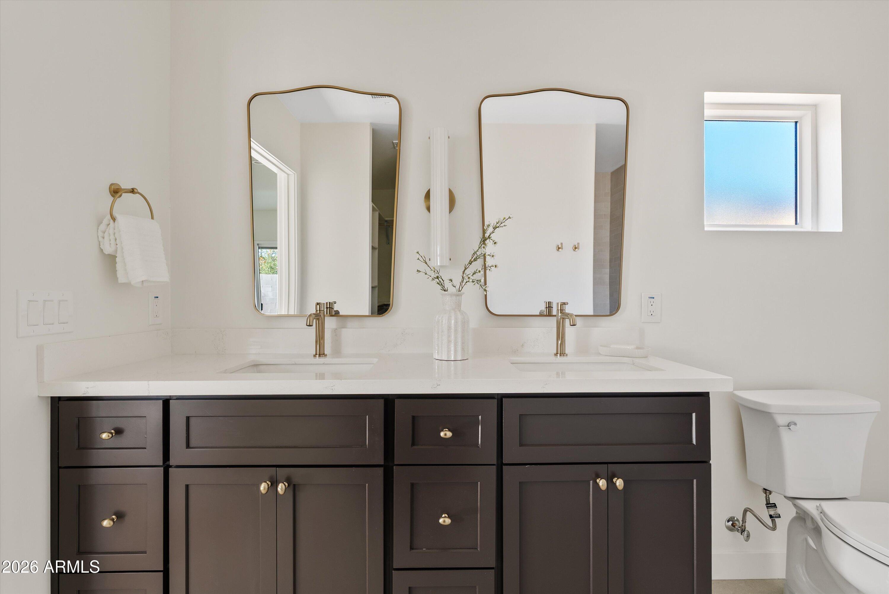 2941 East Cheery Lynn Road Phoenix, AZ 85016 - Photo 3 of 25 a bathroom with double vanity sinks and a mirror