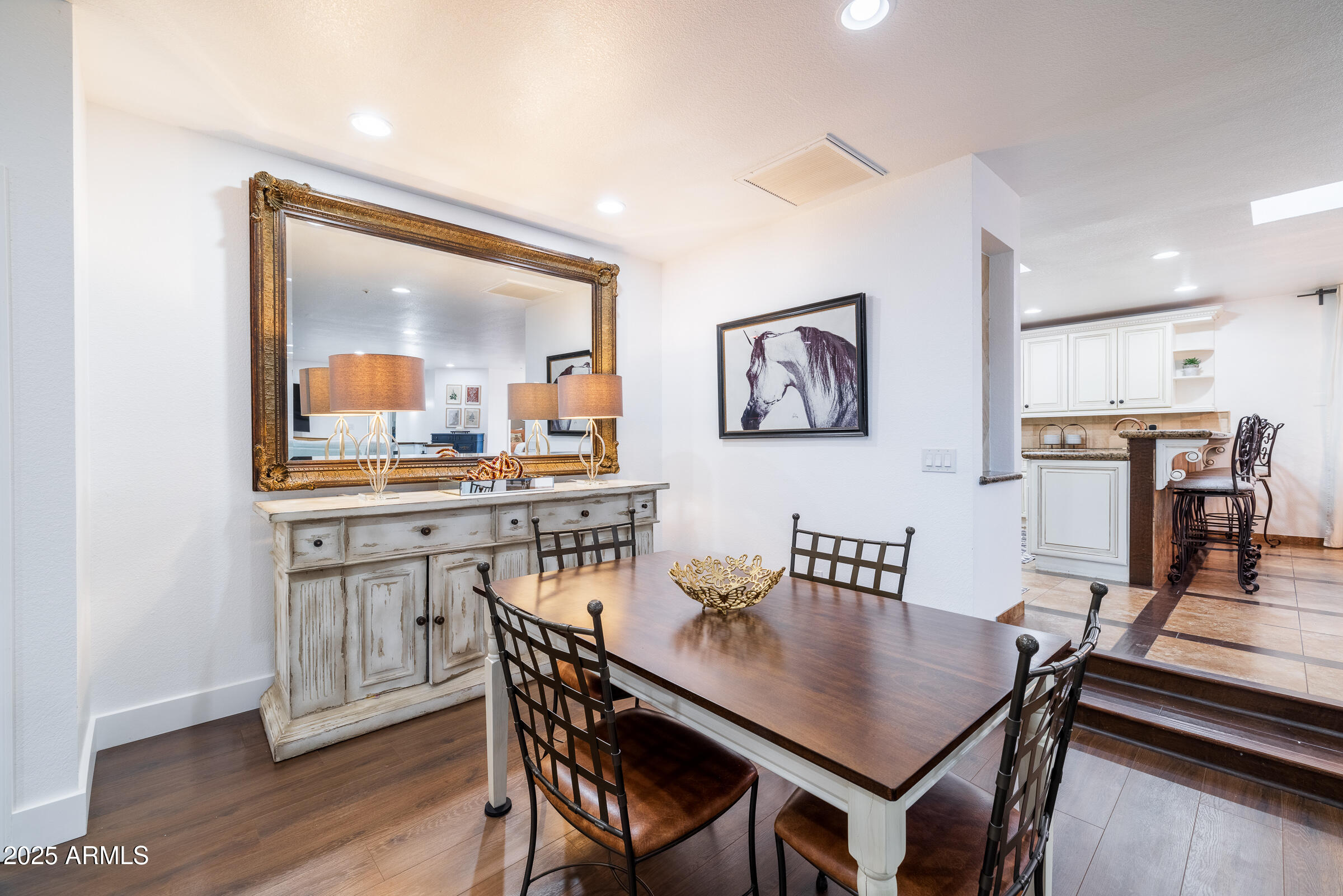 6835 East Peak View Road Scottsdale, AZ 85266 - Photo 11 of 107 a view of a dining room with furniture and wooden floor