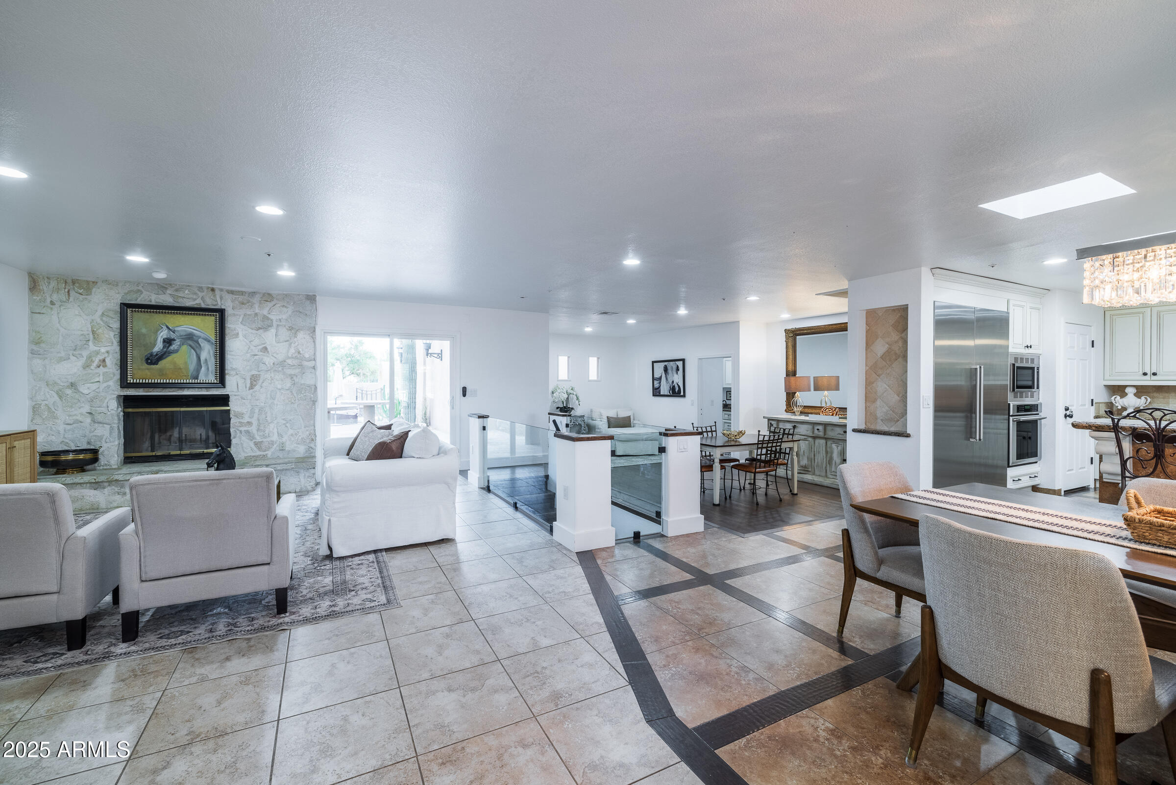 6835 East Peak View Road Scottsdale, AZ 85266 - Photo 13 of 107 a living room with couches and kitchen view with wooden floor