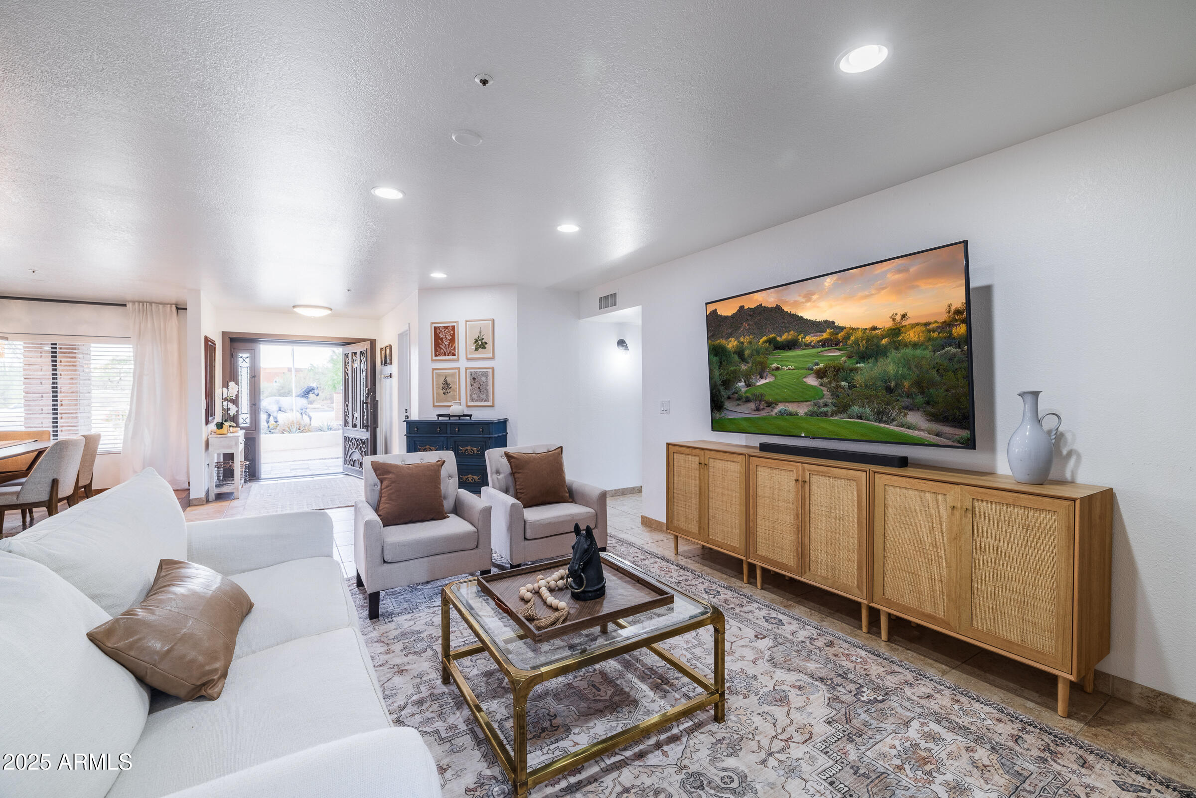 6835 East Peak View Road Scottsdale, AZ 85266 - Photo 16 of 107 a living room with furniture a flat screen tv and a window