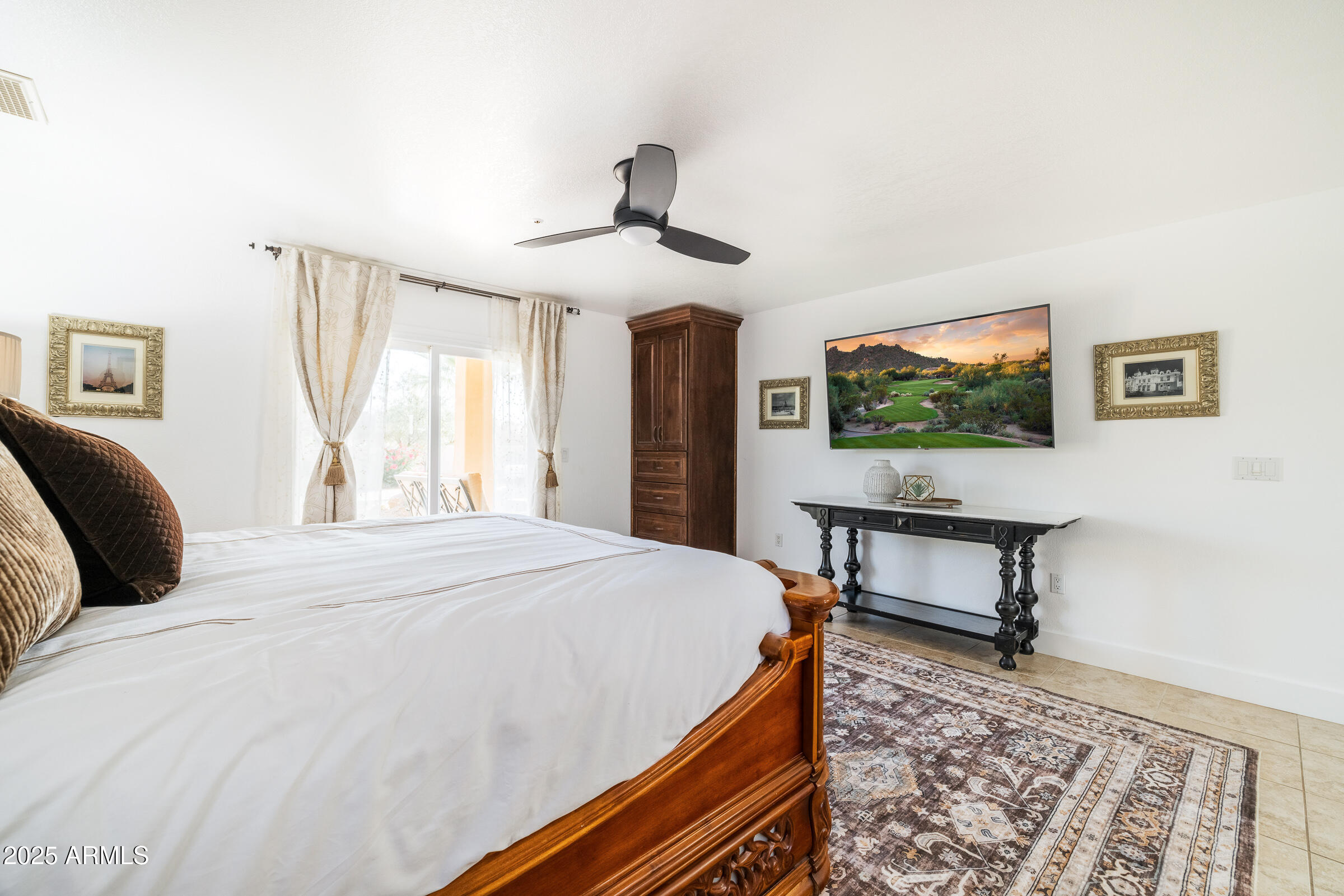 6835 East Peak View Road Scottsdale, AZ 85266 - Photo 19 of 107 a bedroom with a bed and a chandelier