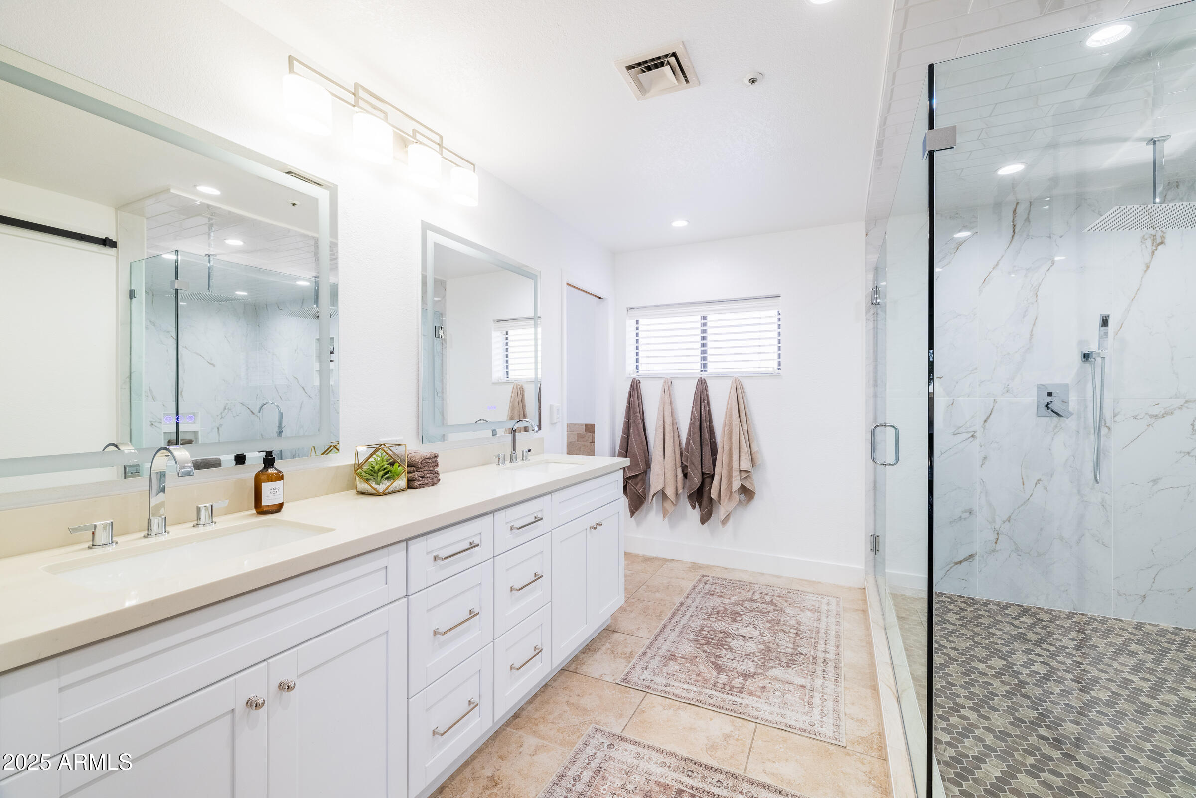 6835 East Peak View Road Scottsdale, AZ 85266 - Photo 23 of 107 a spacious bathroom with a shower sink and mirror