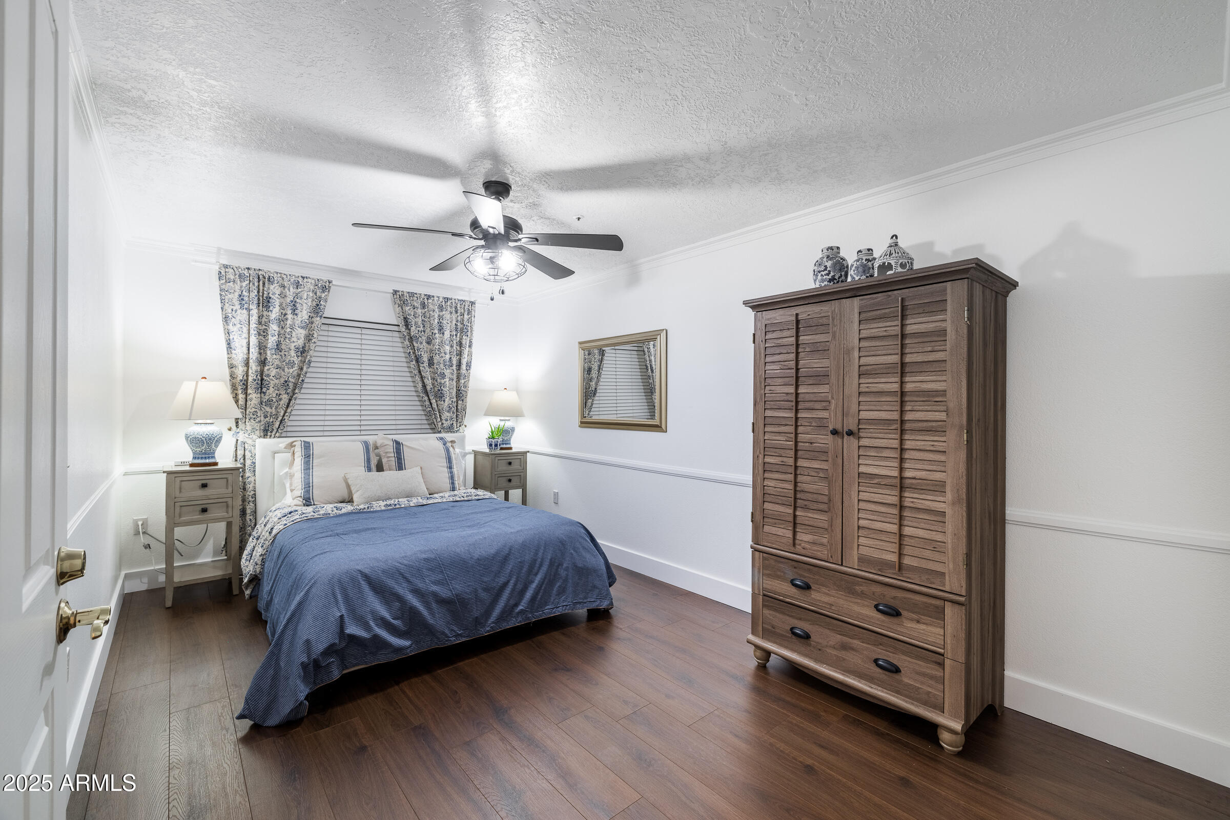 6835 East Peak View Road Scottsdale, AZ 85266 - Photo 68 of 107 a bedroom with a bed and a chandelier