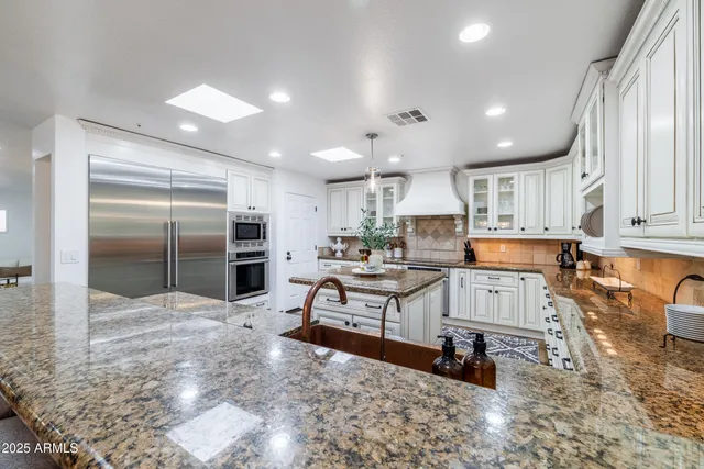 a living room with furniture a flat screen tv and a window