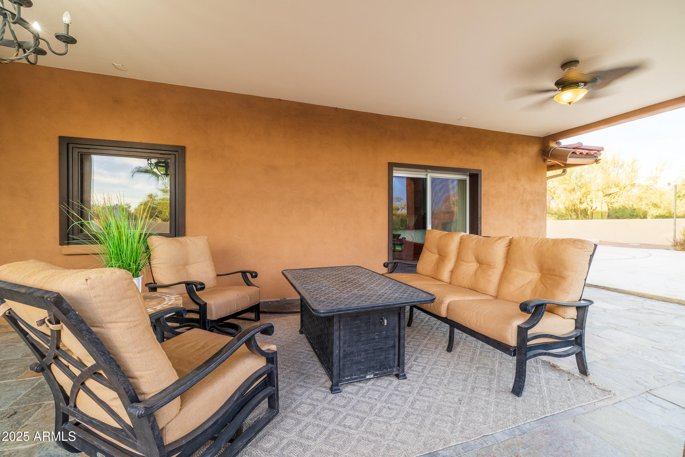 6835 East Peak View Road Scottsdale, AZ 85266 - Photo 76 of 107 a living room with furniture and a potted plant