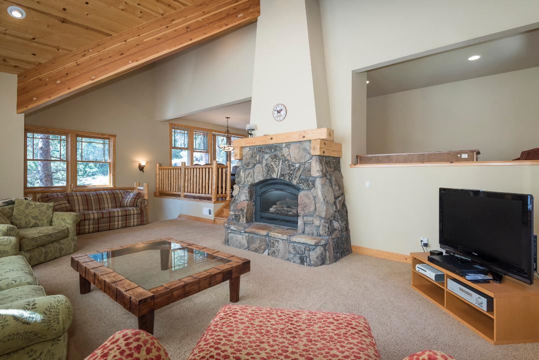 135 Alpine Meadows Road, Unit 32 Alpine Meadows, CA 96145 - Photo 20 of 20 a living room with furniture a flat screen tv and a fireplace