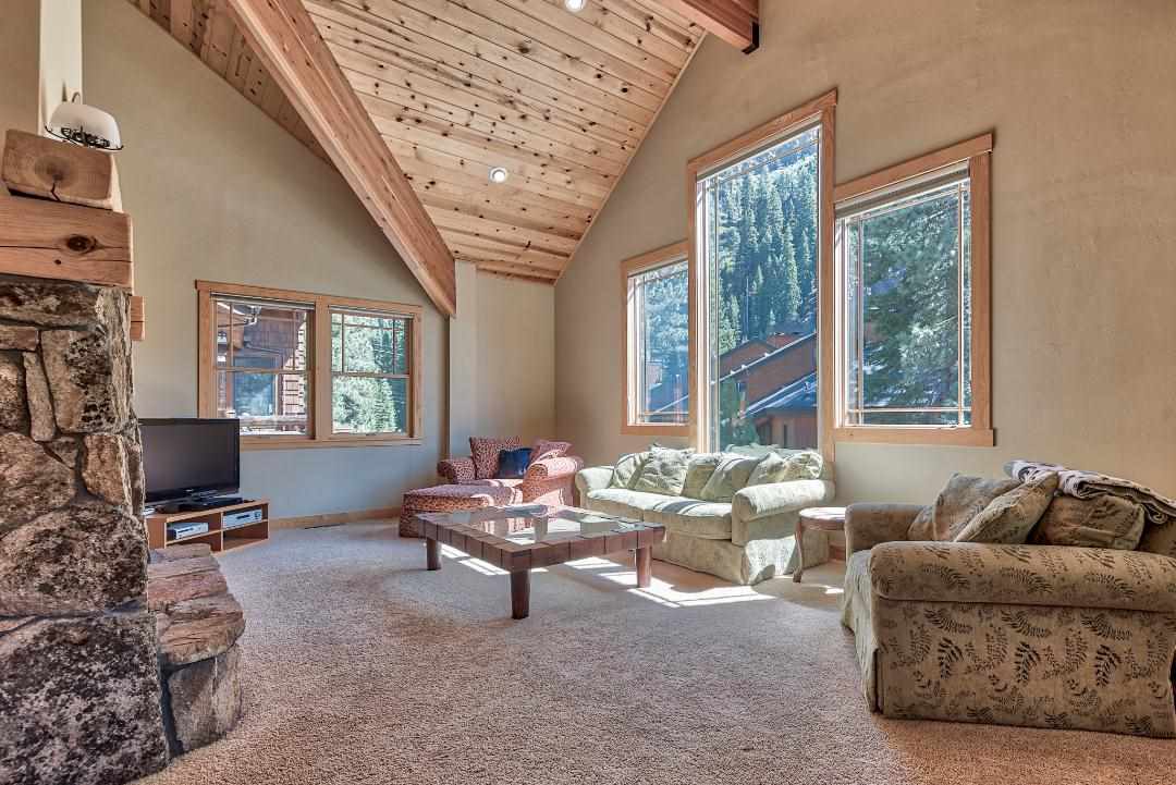 135 Alpine Meadows Road, Unit 32 Alpine Meadows, CA 96145 - Photo 2 of 20 a living room with furniture and a flat screen tv