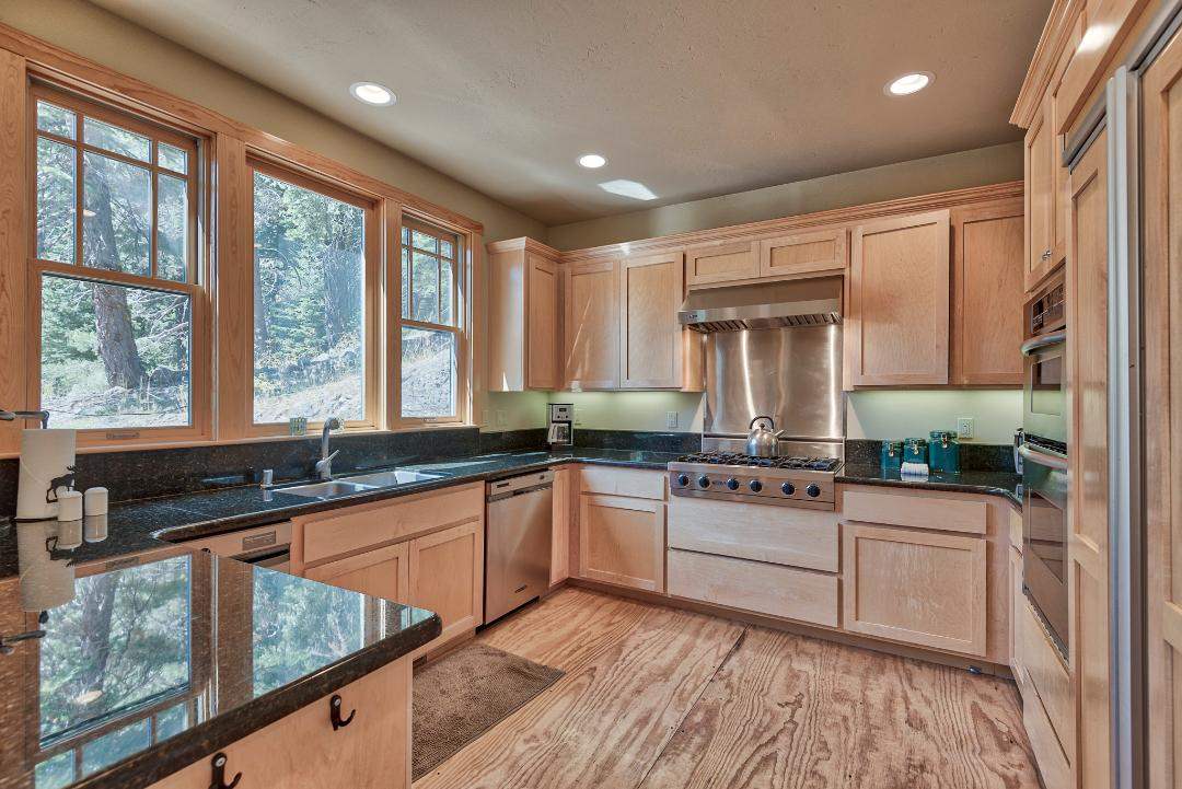 135 Alpine Meadows Road, Unit 32 Alpine Meadows, CA 96145 - Photo 5 of 20 a kitchen with stainless steel appliances granite countertop sink stove and refrigerator