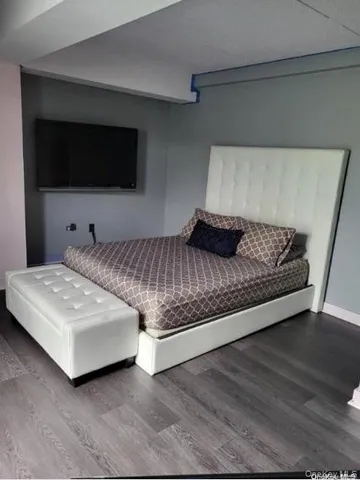 a living room with a flat screen tv and a couch