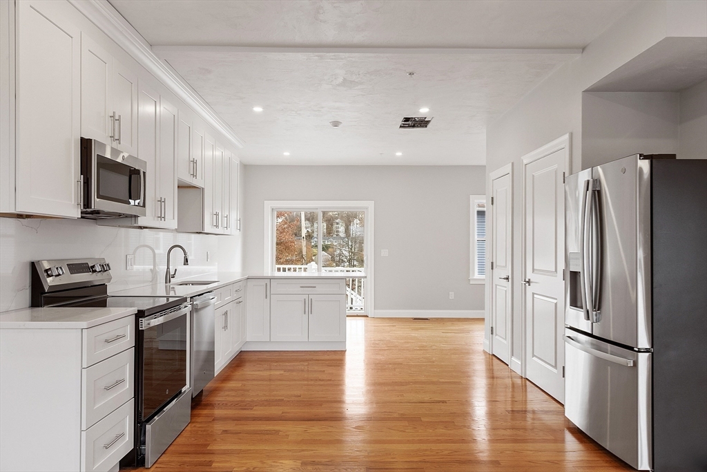 10 Windsor Street Worcester, MA 01605 - Photo 4 of 26 a kitchen with stainless steel appliances a refrigerator sink and microwave