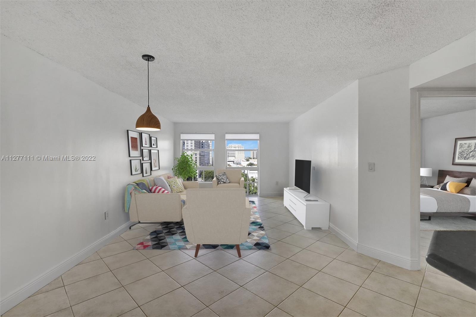 a living room with furniture a window and a chandelier