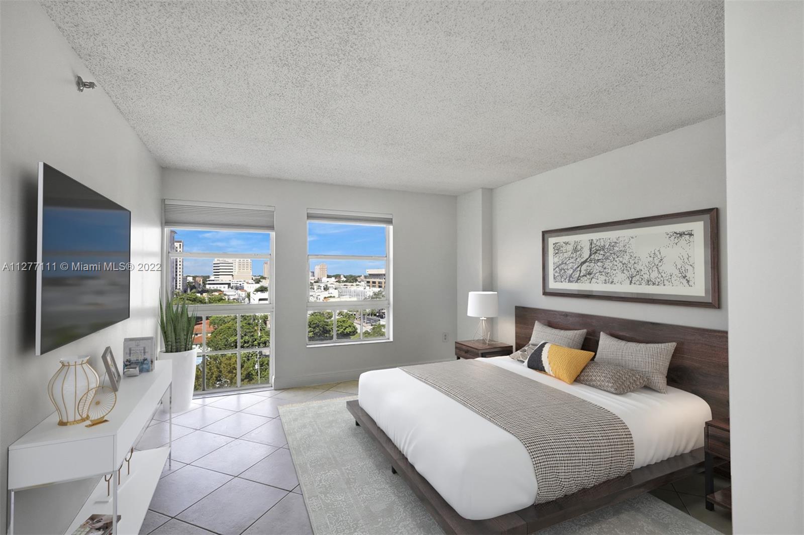 2351 Douglas Road, Unit 908 Miami, FL 33145 - Photo 14 of 37 a bedroom with a large bed and a flat screen tv