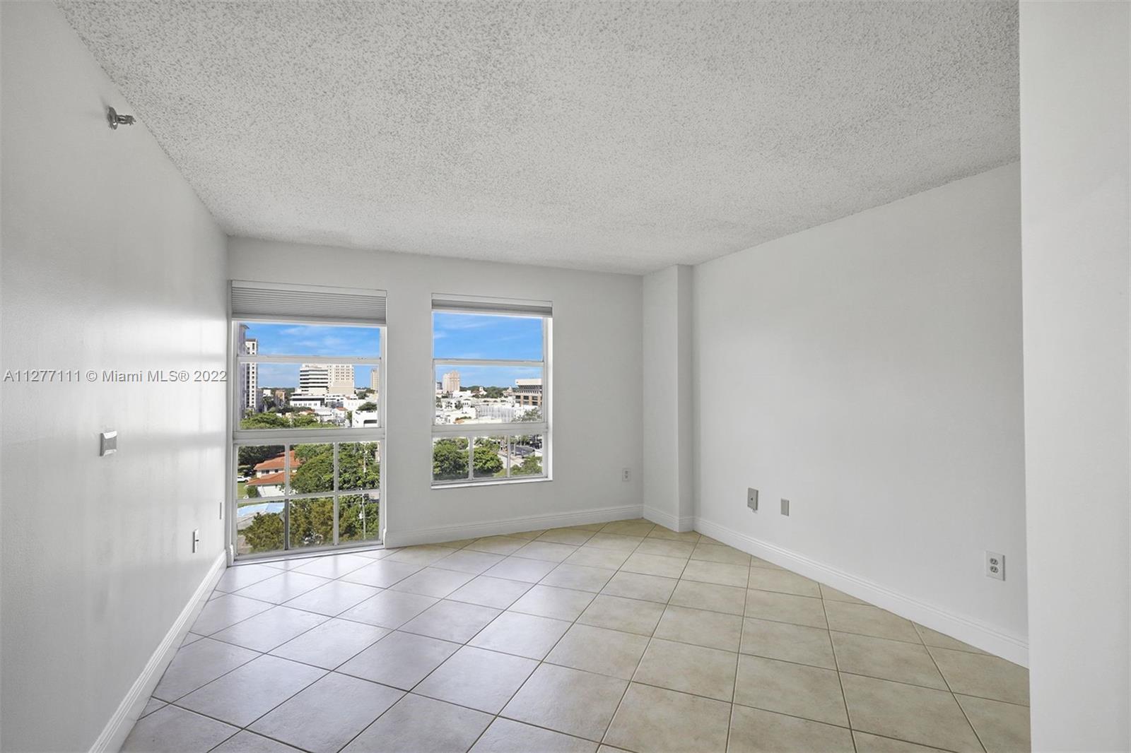 2351 Douglas Road, Unit 908 Miami, FL 33145 - Photo 19 of 37 a view of an empty room with a window