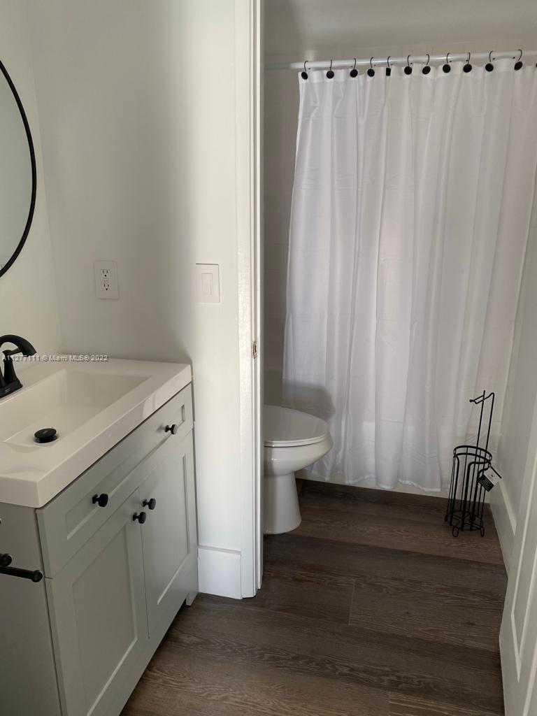 2351 Douglas Road, Unit 908 Miami, FL 33145 - Photo 24 of 37 a bathroom with a sink and a mirror