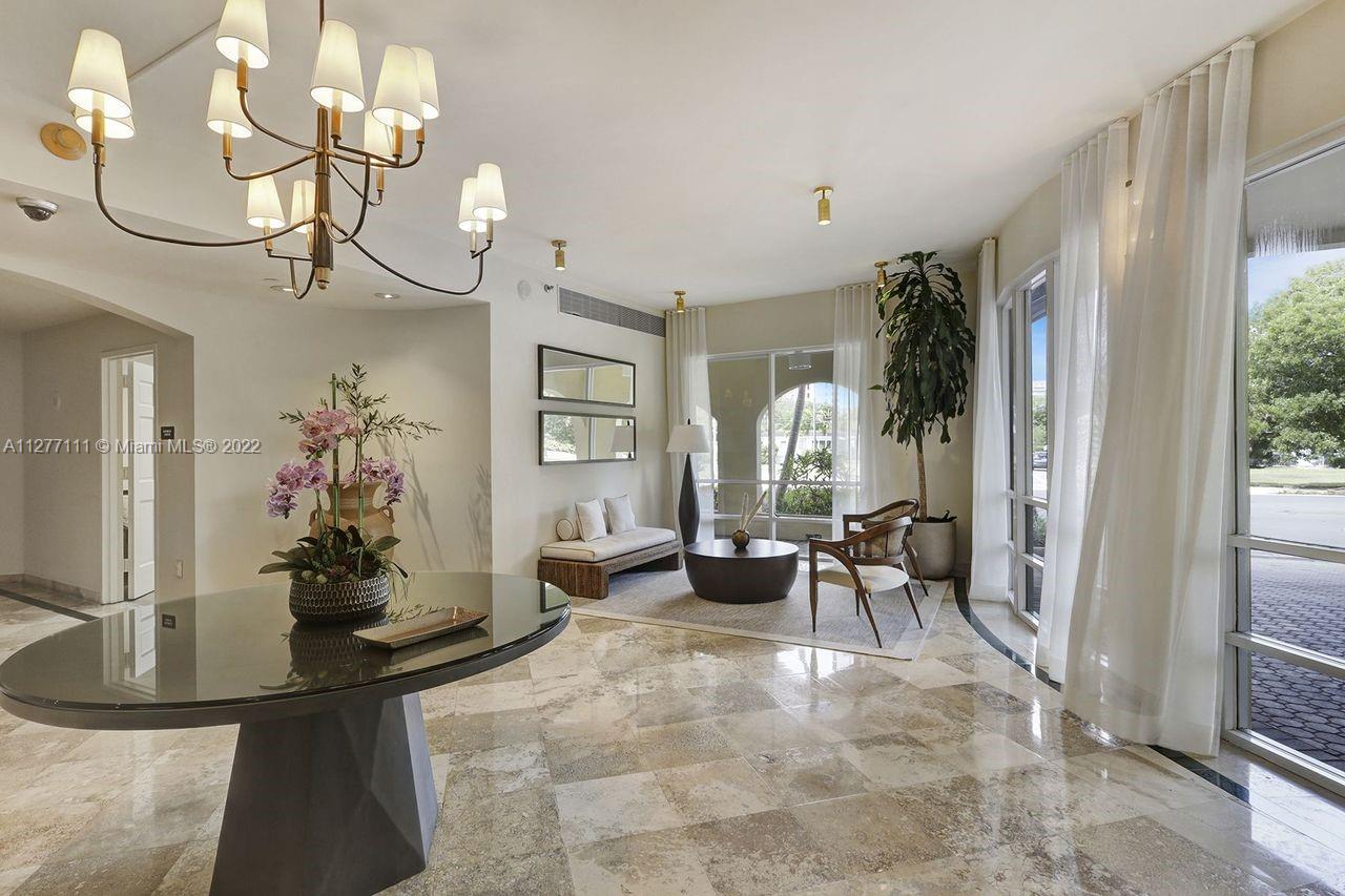 2351 Douglas Road, Unit 908 Miami, FL 33145 - Photo 28 of 37 a view of a dining room with furniture and a chandelier