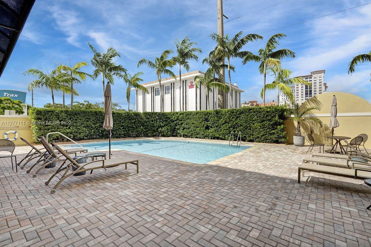 2351 Douglas Road, Unit 908 Miami, FL 33145 - Photo 33 of 37 a view of a patio with a table and chairs