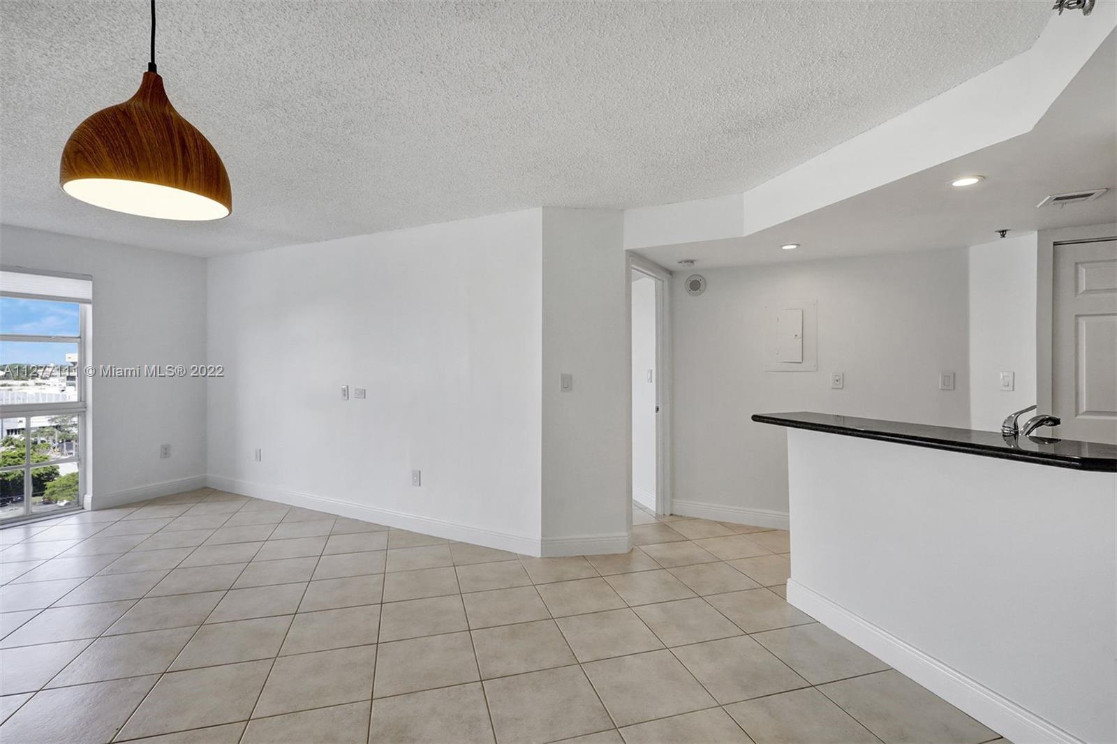 2351 Douglas Road, Unit 908 Miami, FL 33145 - Photo 5 of 37 a view of an empty room with a window
