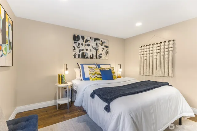 a bedroom with a bed and wooden floor