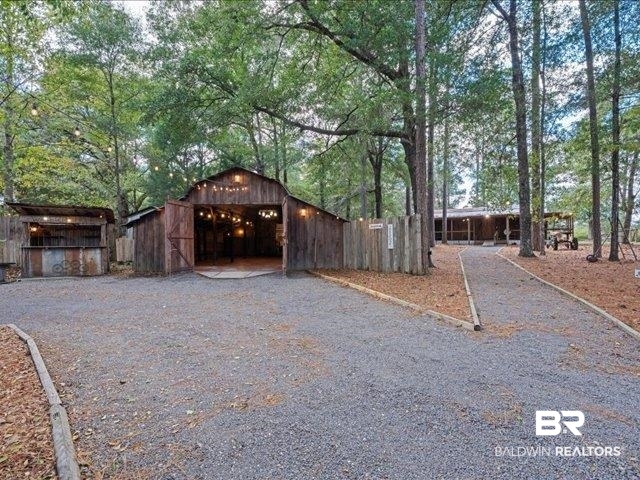 4650 Wiggins Lane Wilmer, AL 36587 - Photo 39 of 66 View of home's exterior featuring an outbuilding and a detached garage