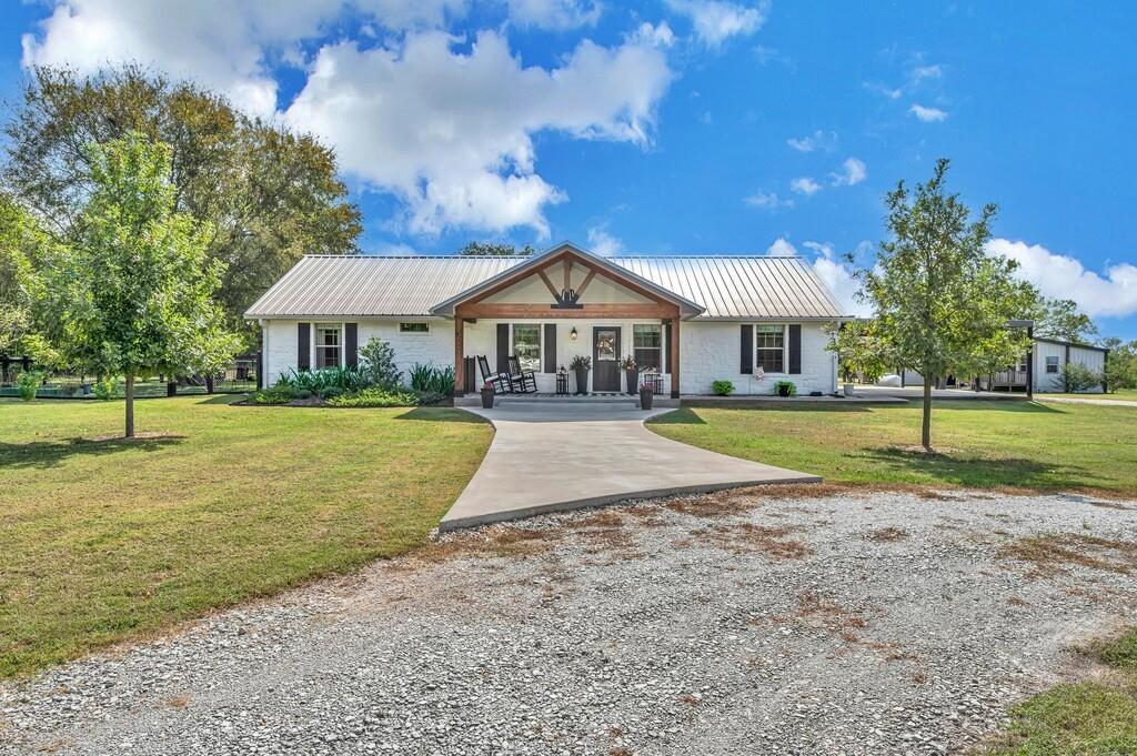 a view of a house with a yard