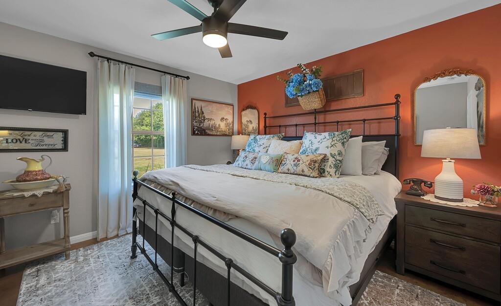 655 Buster Chatham Road Waco, TX 76705 - Photo 20 of 40 a bedroom with a bed and a flat screen tv