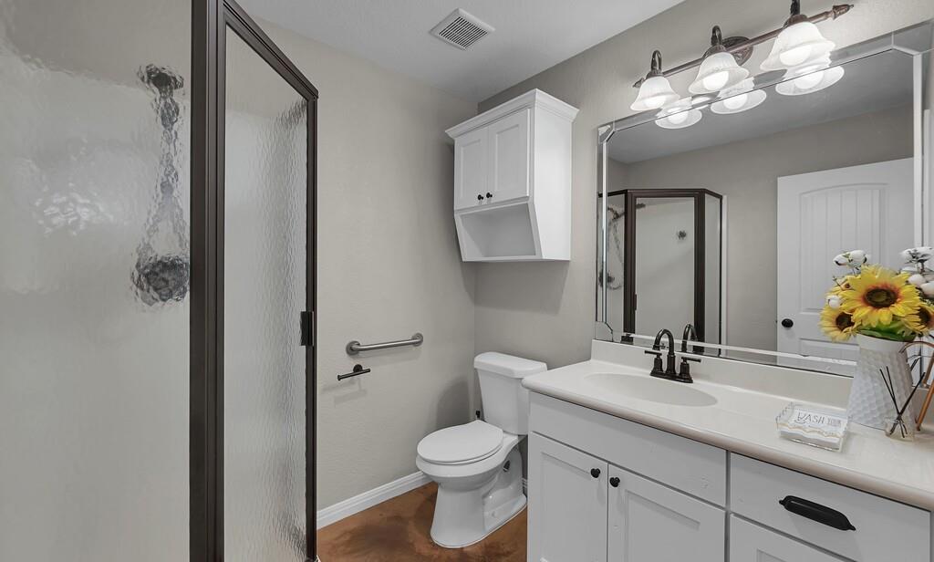 655 Buster Chatham Road Waco, TX 76705 - Photo 23 of 40 a bathroom with a toilet sink and mirror