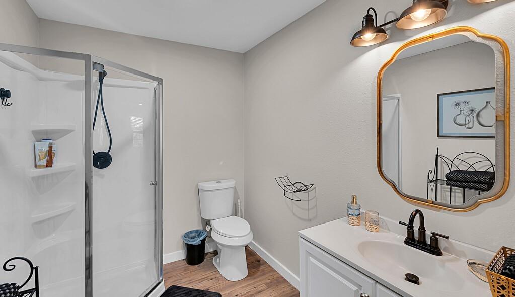 655 Buster Chatham Road Waco, TX 76705 - Photo 34 of 40 a bathroom with a sink mirror and toilet