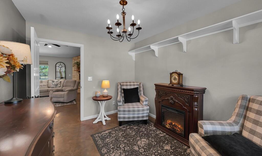 655 Buster Chatham Road Waco, TX 76705 - Photo 5 of 40 a living room with furniture and a fireplace