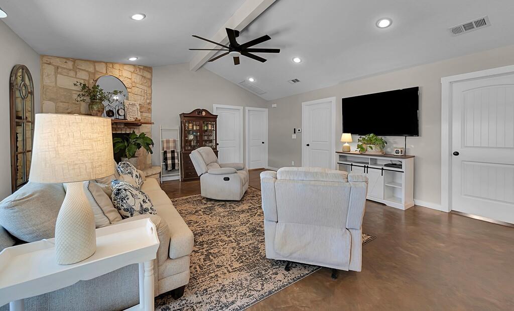 655 Buster Chatham Road Waco, TX 76705 - Photo 8 of 40 a living room with furniture and a flat screen tv