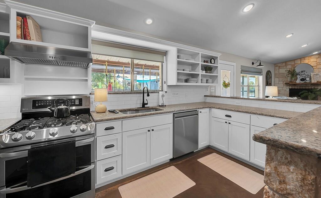 655 Buster Chatham Road Waco, TX 76705 - Photo 10 of 40 a kitchen with stainless steel appliances granite countertop a sink stove and cabinets