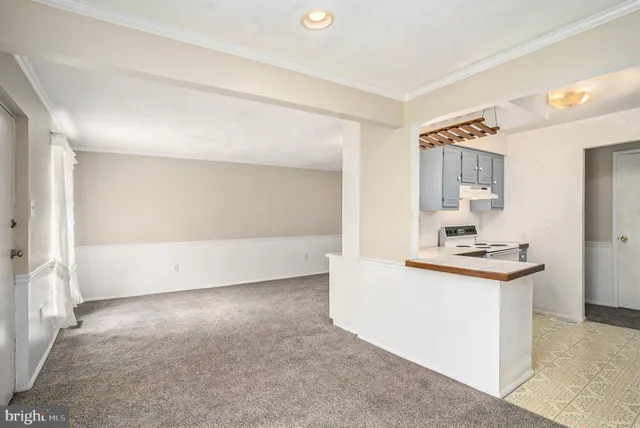 a view of a kitchen with a sink and a refrigerator