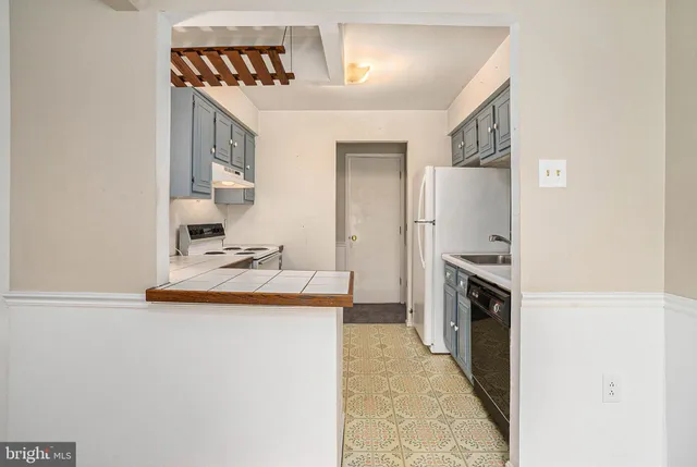 a kitchen with kitchen island a stove a sink and a refrigerator