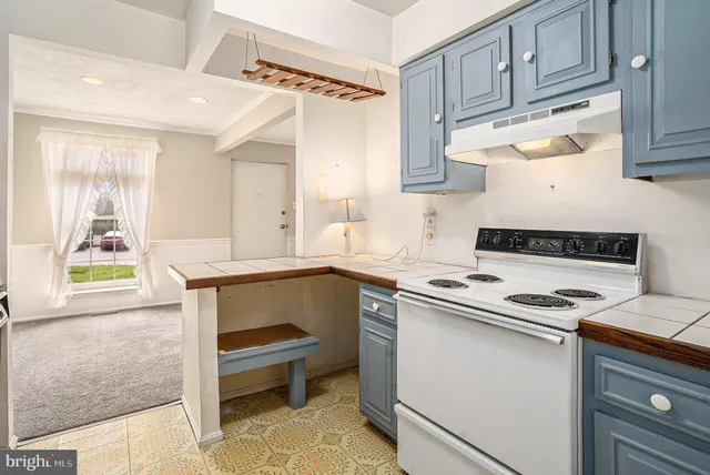 a kitchen with granite countertop a stove and a sink