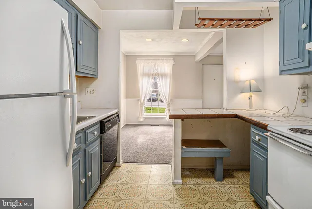 a hallway with a sink and a stove top oven