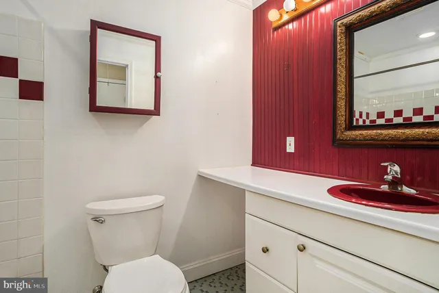 a bathroom with a toilet sink and mirror