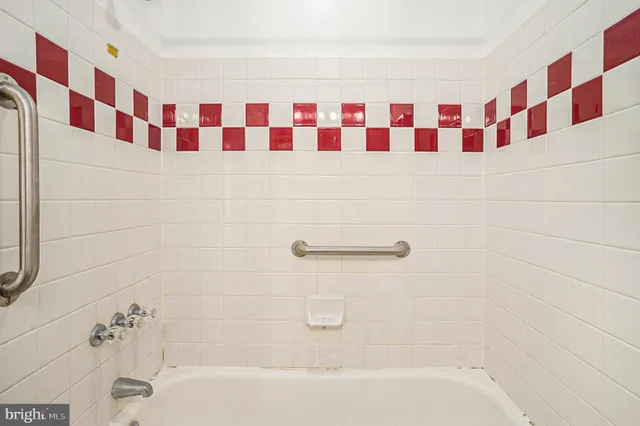 a bathroom with a black and white checkered floor