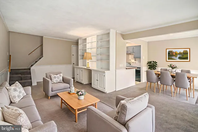 a living room with furniture and view of kitchen