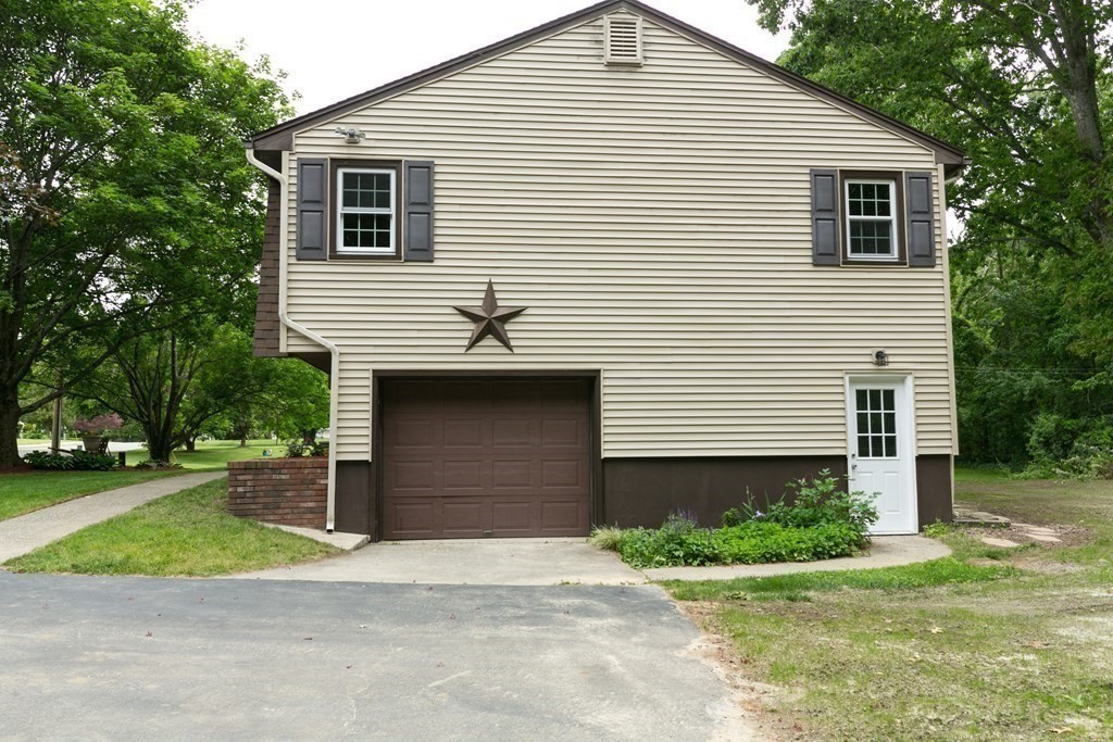 34 Heritage Road Sutton, MA 01590 - Photo 27 of 33 a front view of a house with a yard and garage