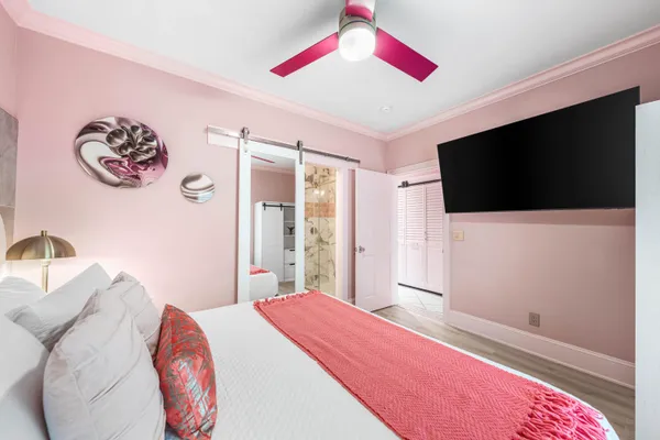 a bedroom with a bed and a view of walk in closet