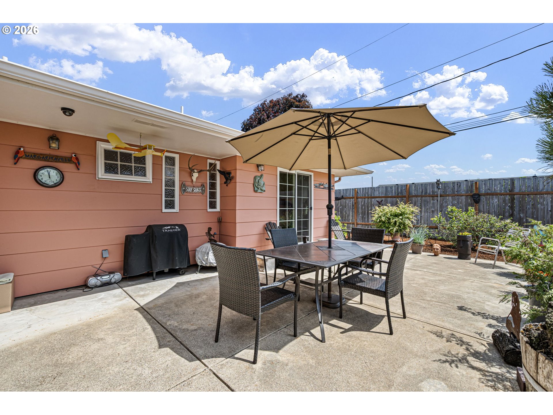 2465 17th Street Springfield, OR 97477 - Photo 41 of 47 a view of a patio with a table and chairs under an umbrella