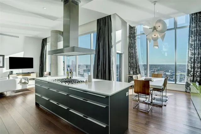 a living room with dining table furniture and a flat screen tv