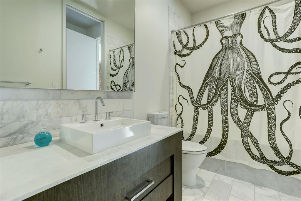 210 Lavaca Street, Unit 3401 Austin, TX 78701 - Photo 15 of 19 a bathroom with a sink and mirror with bathtub