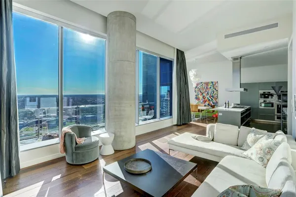 a living room with furniture and a wooden floor
