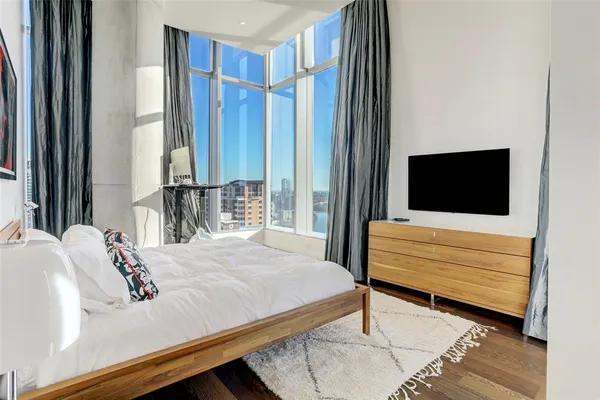 a bedroom with a bed and a flat screen tv