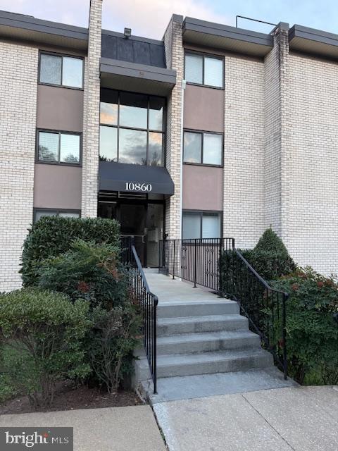 10860-10864 Bucknell Drive, Unit 301 Silver Spring, MD 20902 - Photo 1 of 27 a front view of a house with a yard