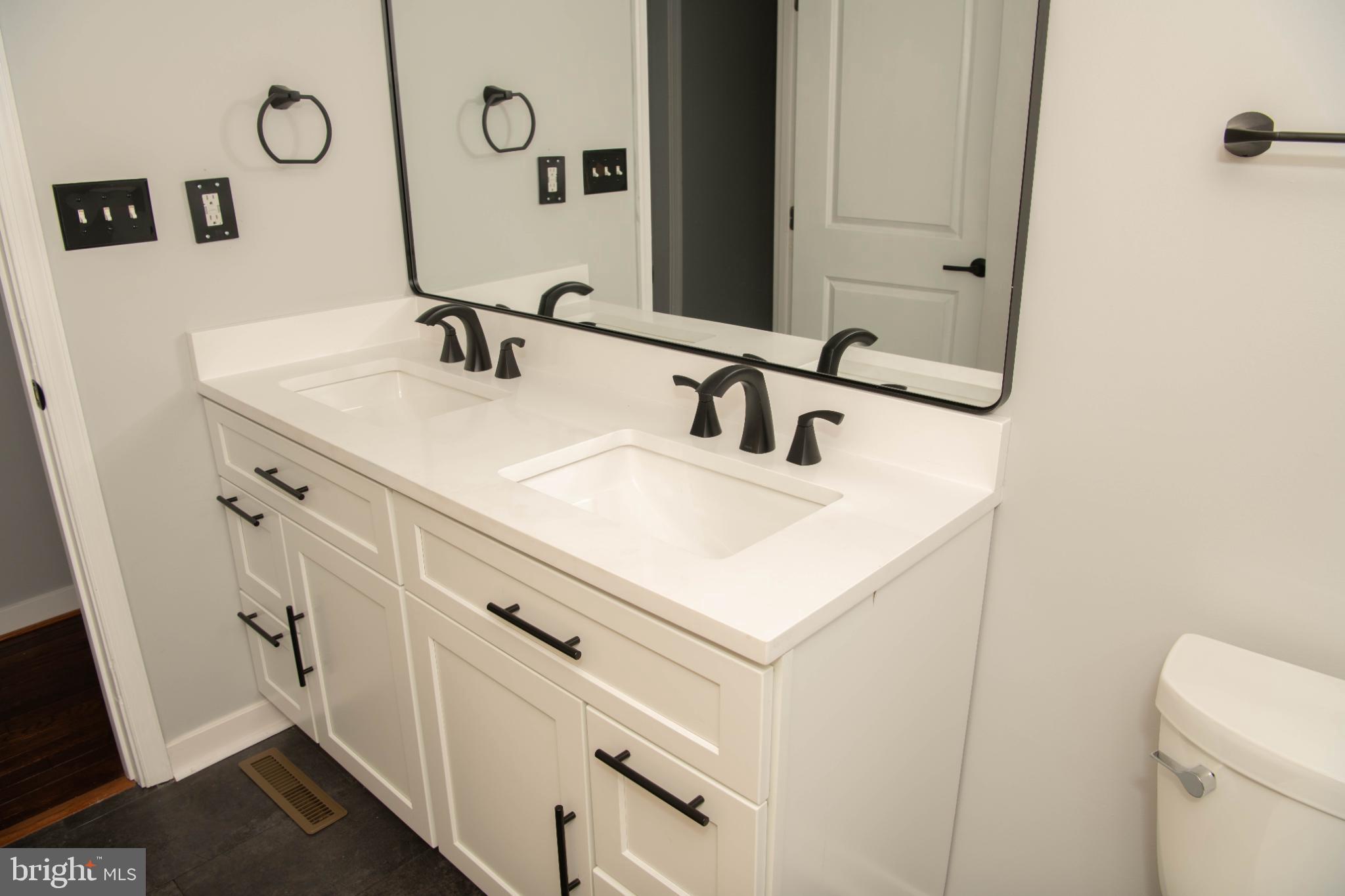 4785 Mountain Road Pasadena, MD 21122 - Photo 18 of 30 Sleek dual vanity in modern bathroom design.
