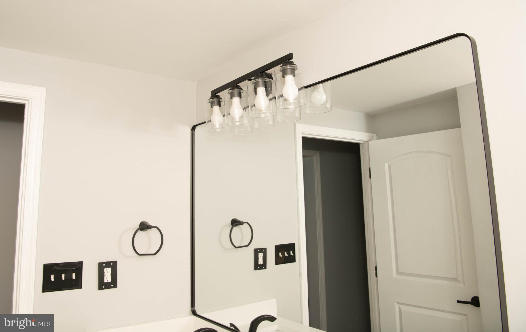 4785 Mountain Road Pasadena, MD 21122 - Photo 19 of 30 Sleek modern bathroom with stylish lighting.
