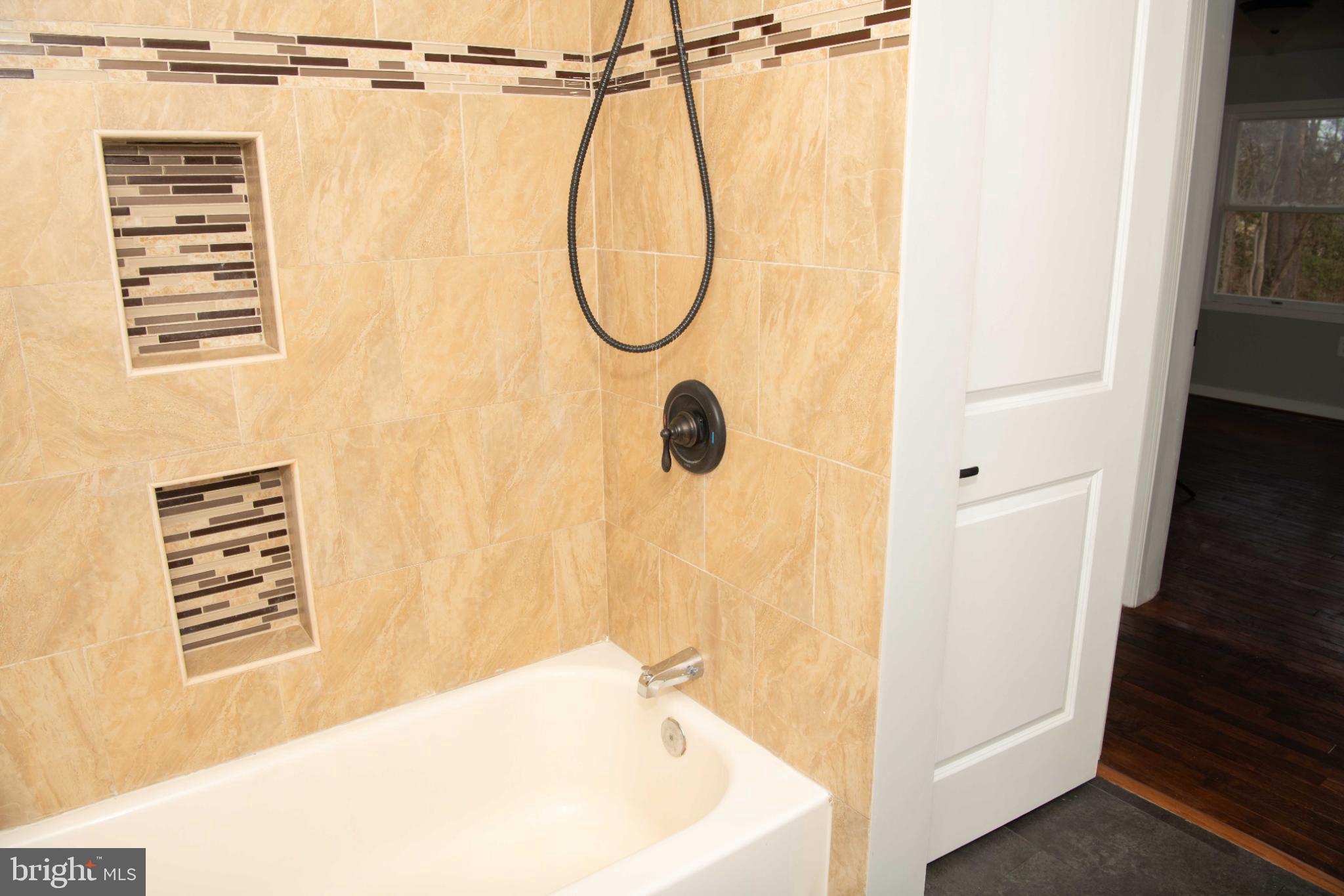 4785 Mountain Road Pasadena, MD 21122 - Photo 20 of 30 Elegant main bathroom with modern tile accents.