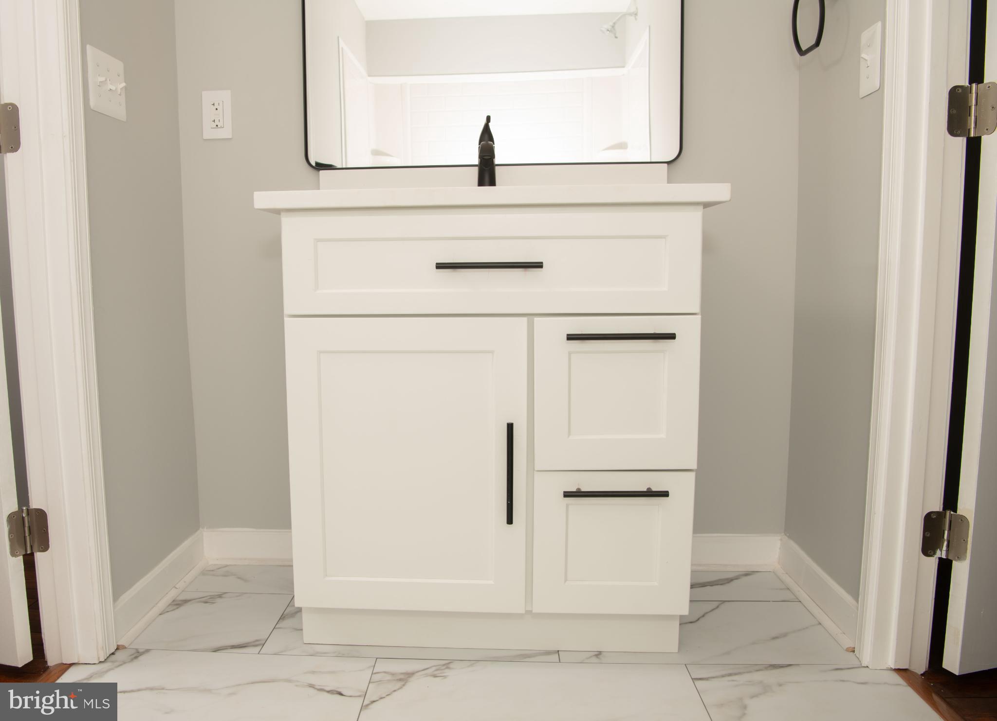 4785 Mountain Road Pasadena, MD 21122 - Photo 21 of 30 Sleek modern buddy bath vanity in serene tones.
