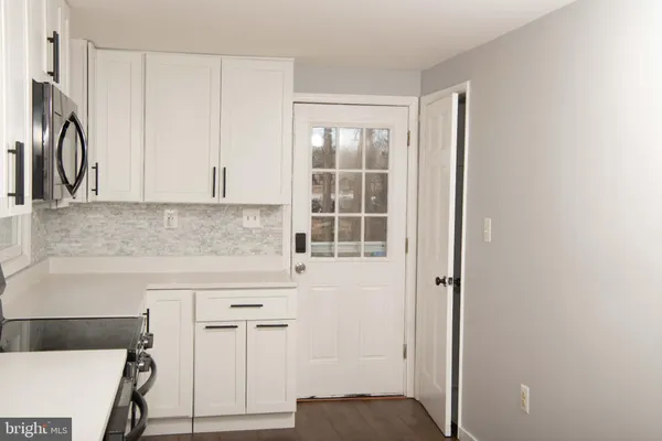 a kitchen with stainless steel appliances granite countertop a refrigerator and a stove